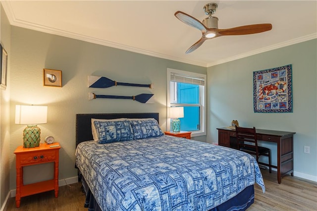 bedroom with hardwood / wood-style flooring, crown molding, and ceiling fan