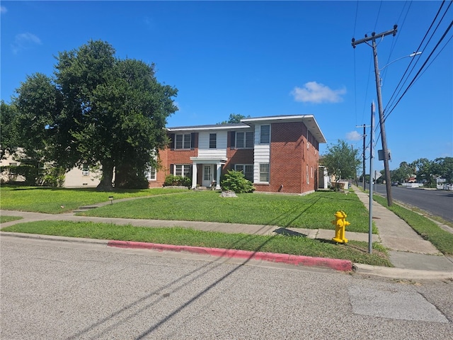 253 Leming Ave, Corpus Christi, TX 78404 - view of front of home with brick siding and a front yard