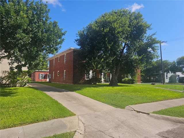 253 Leming Ave, Corpus Christi, TX 78404 - view of front of property with brick siding, driveway, and a front lawn