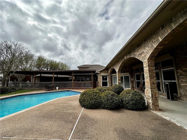 view of pool featuring a patio area, fence, and a fenced in pool