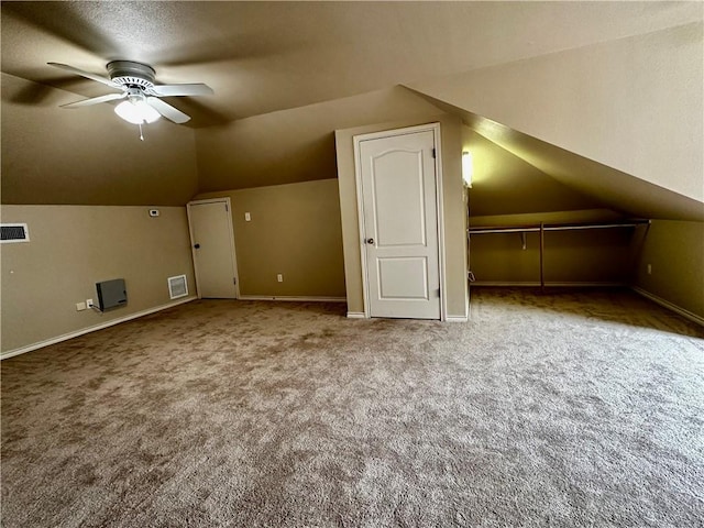 additional living space featuring carpet floors, baseboards, visible vents, and a ceiling fan