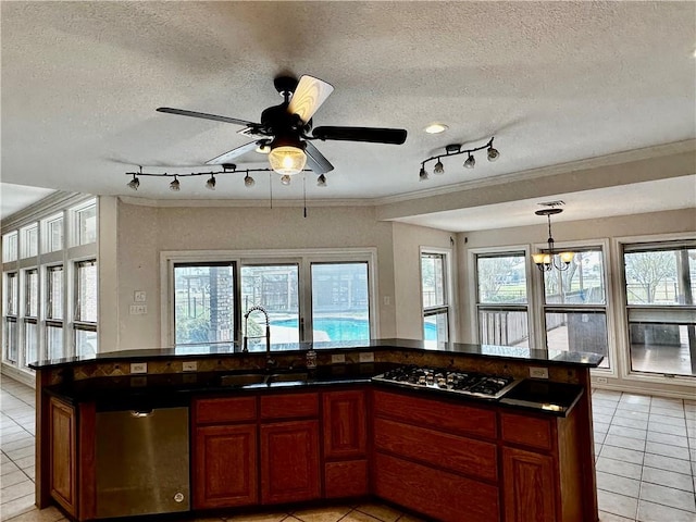 kitchen featuring light tile patterned floors, plenty of natural light, stainless steel appliances, and a sink