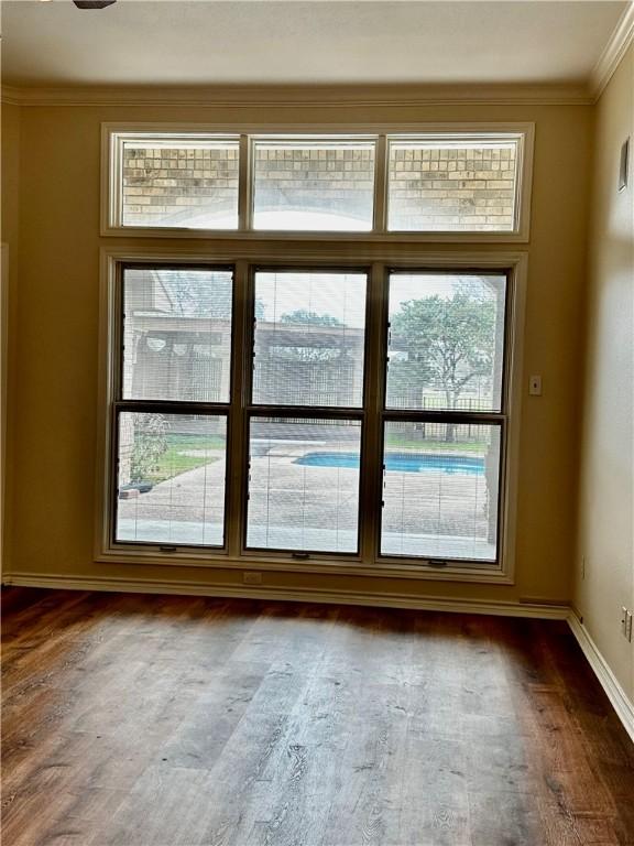 entryway featuring baseboards, dark wood finished floors, and crown molding