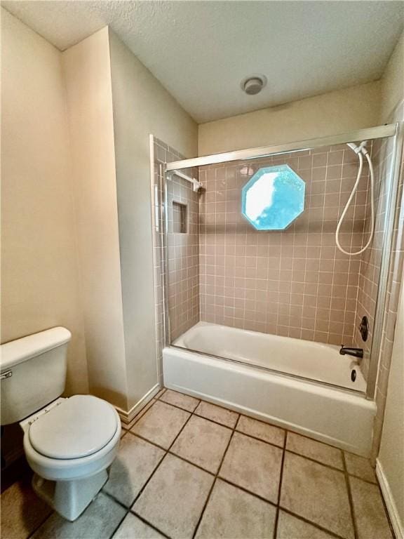 full bathroom featuring baseboards, shower / tub combination, toilet, and tile patterned floors