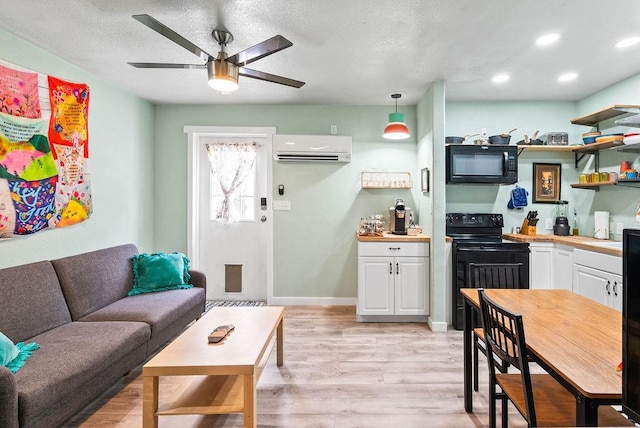 256 Melrose St, Corpus Christi, TX 78404 - living room featuring an AC wall unit, light wood-style floors, ceiling fan, recessed lighting, and a textured ceiling