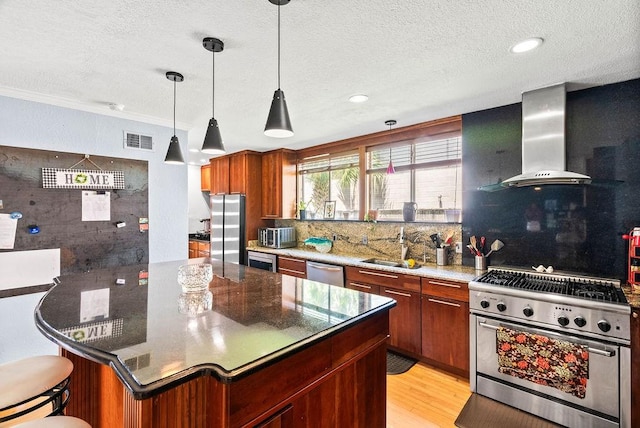 256 Melrose St, Corpus Christi, TX 78404 - kitchen with stainless steel appliances, a textured ceiling, decorative backsplash, wall chimney range hood, and pendant lighting
