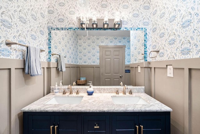256 Melrose St, Corpus Christi, TX 78404 - bathroom featuring wallpapered walls, double vanity, a wainscoted wall, and a decorative wall