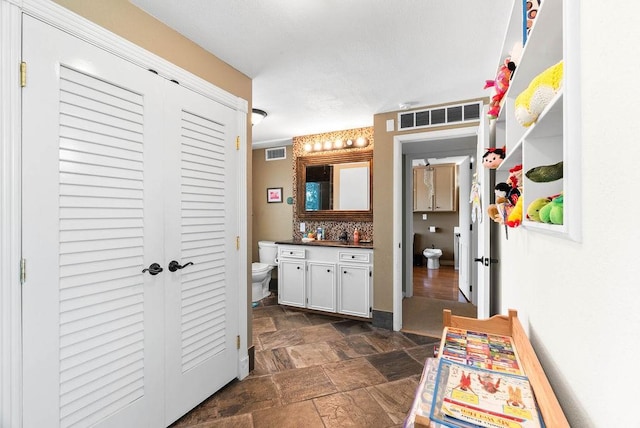 256 Melrose St, Corpus Christi, TX 78404 - bathroom featuring a closet, vanity, and stone finish flooring