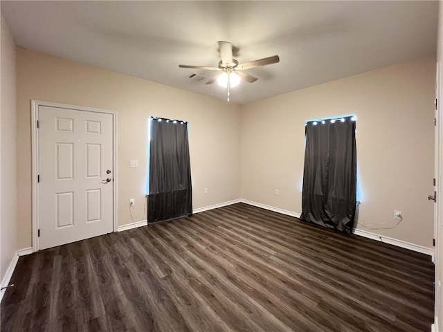 unfurnished room with ceiling fan and dark hardwood / wood-style floors