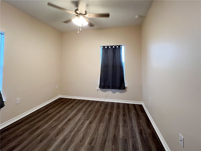 spare room featuring ceiling fan and dark hardwood / wood-style floors