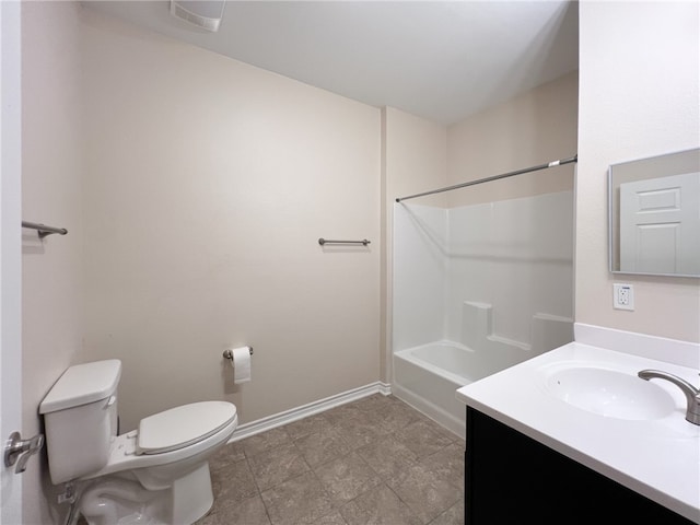 bathroom with toilet, vanity, and tile patterned floors