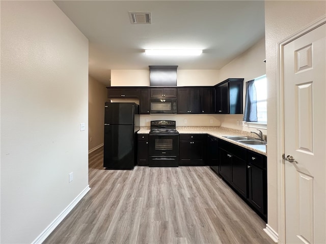 kitchen featuring light hardwood / wood-style floors, sink, and black appliances