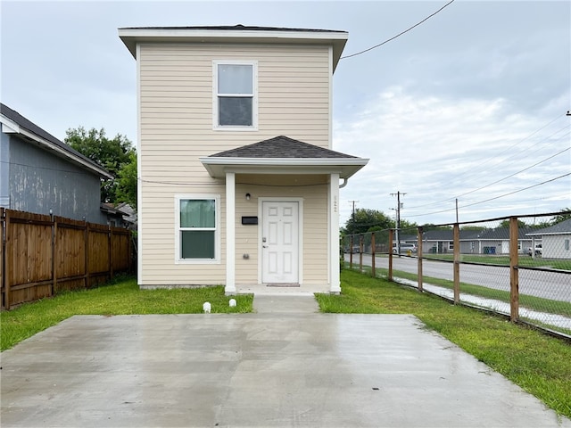 view of front facade with a front yard and a patio area