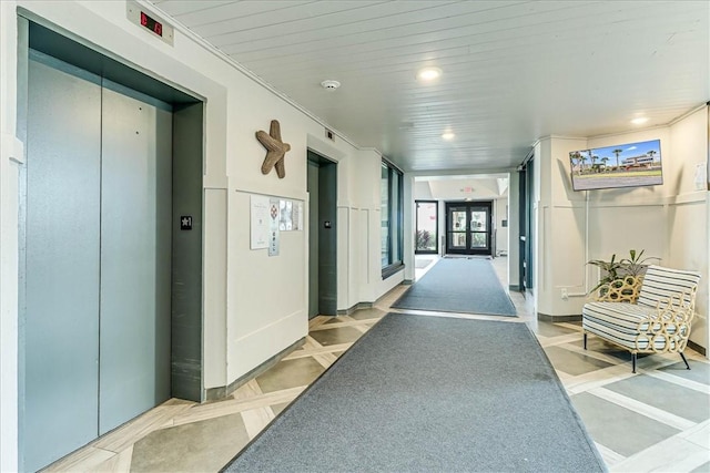 hall featuring recessed lighting and elevator