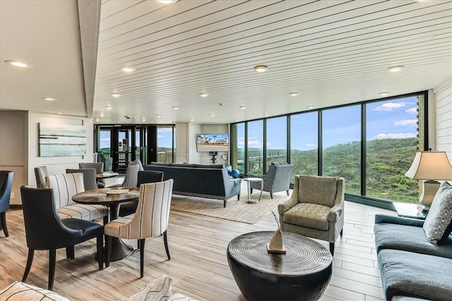 interior space featuring floor to ceiling windows and light wood-style flooring