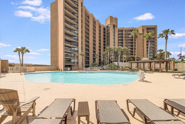 pool with a patio and fence