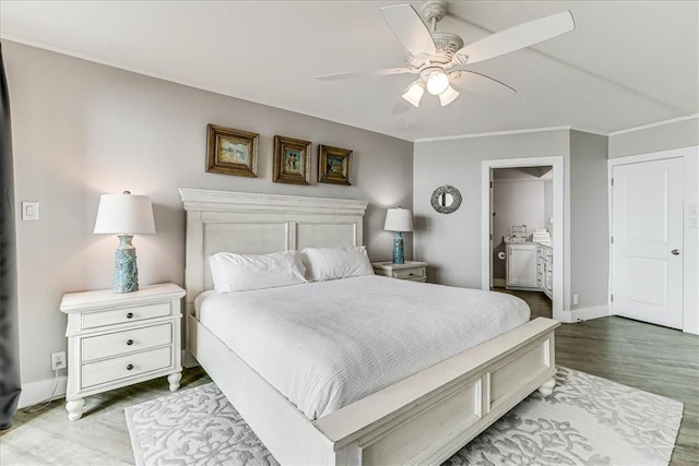 bedroom featuring crown molding, connected bathroom, ceiling fan, baseboards, and wood finished floors