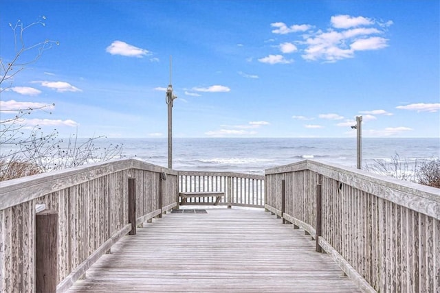 surrounding community featuring a beach view and a water view
