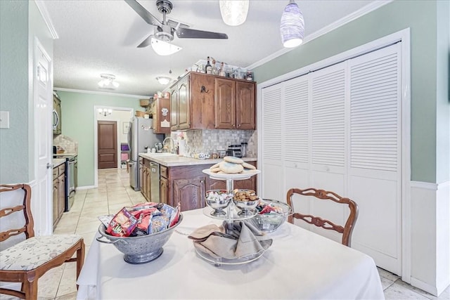 dining area with ceiling fan, light tile patterned floors, and crown molding