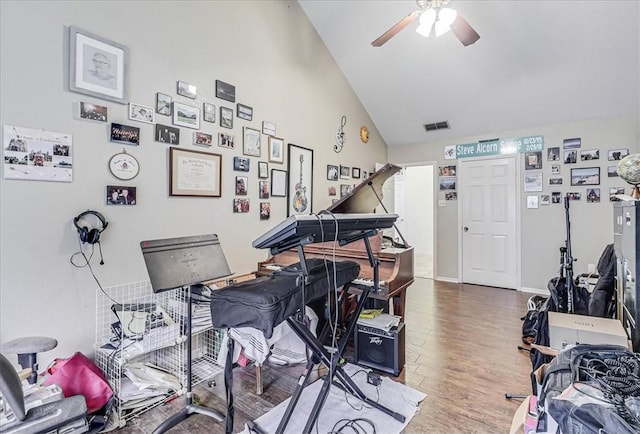 misc room with hardwood / wood-style floors, vaulted ceiling, and ceiling fan