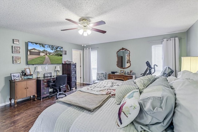 bedroom featuring ceiling fan, dark wood-type flooring, and a textured ceiling