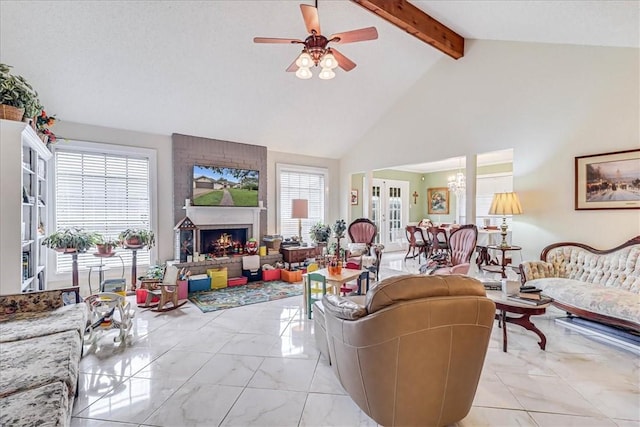 living room with a large fireplace, ceiling fan, beam ceiling, and plenty of natural light