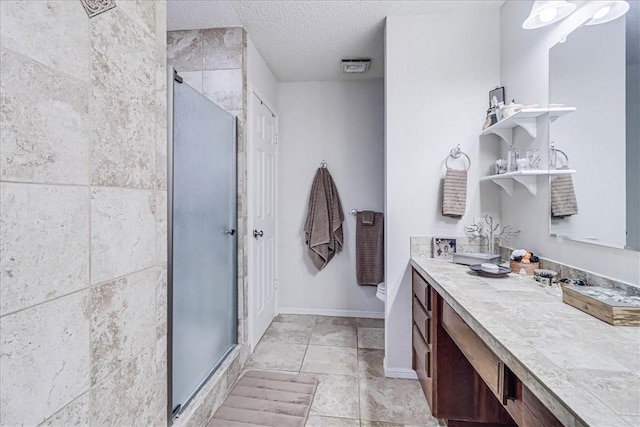 bathroom with vanity, toilet, an enclosed shower, and a textured ceiling