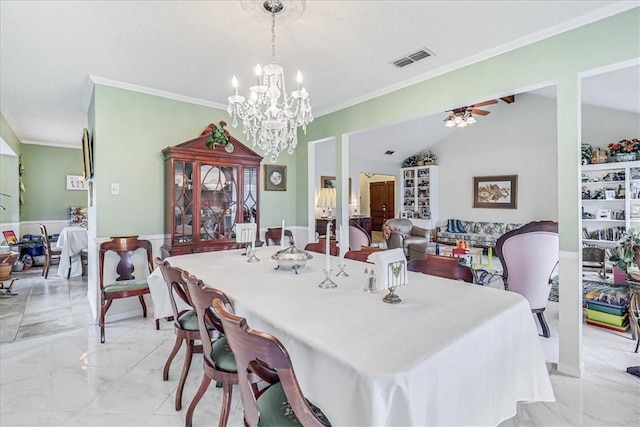 dining room with ceiling fan with notable chandelier and ornamental molding