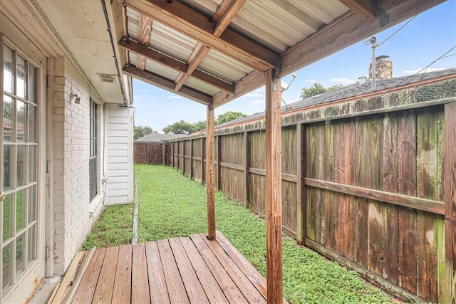 wooden deck featuring a lawn