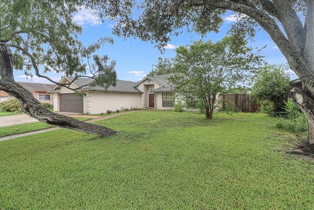 ranch-style house featuring a front yard and a garage