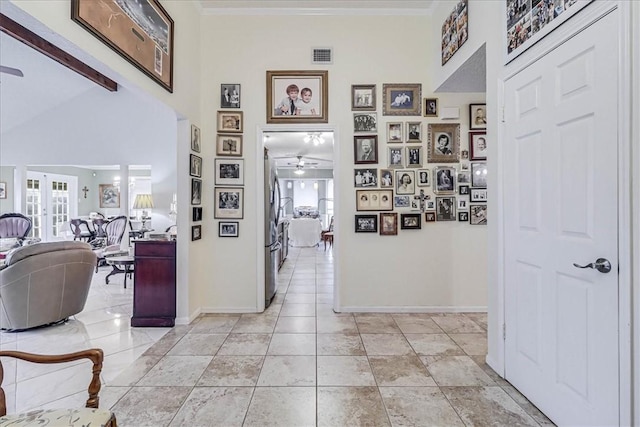 corridor with light tile patterned floors and french doors