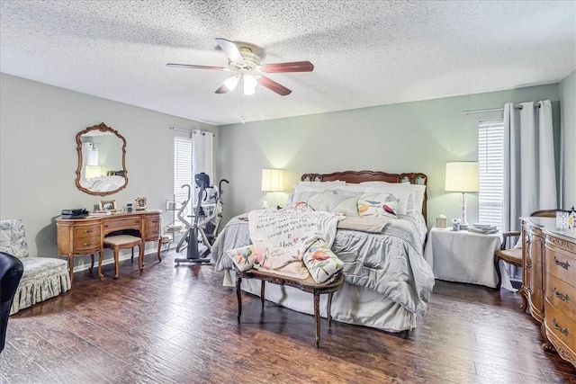 bedroom with a textured ceiling, dark hardwood / wood-style flooring, and ceiling fan