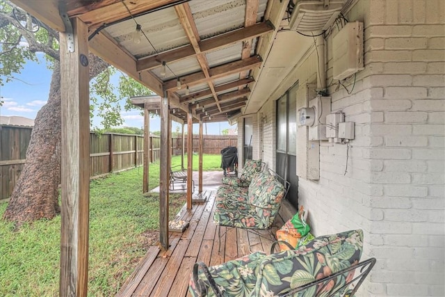 wooden deck featuring a lawn