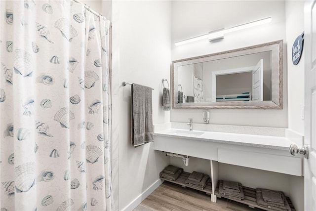 bathroom featuring hardwood / wood-style flooring, vanity, and curtained shower