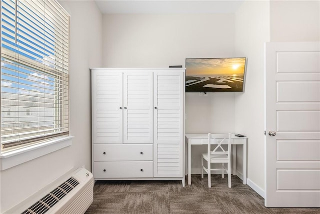 unfurnished bedroom with dark carpet