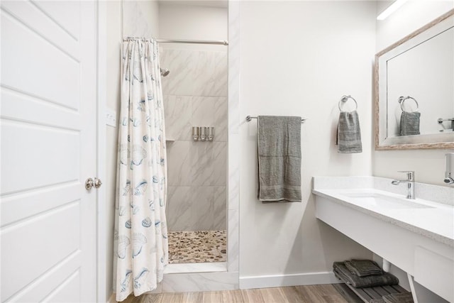 bathroom featuring hardwood / wood-style flooring, sink, and a shower with shower curtain