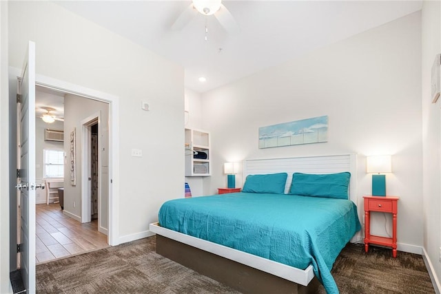 carpeted bedroom featuring ceiling fan and an AC wall unit