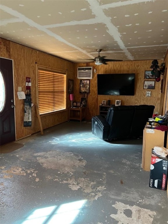 unfurnished living room with wooden walls, a wall mounted air conditioner, and ceiling fan