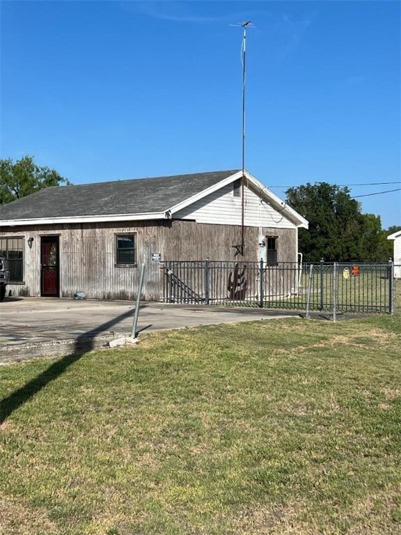 back of house featuring a patio area and a yard