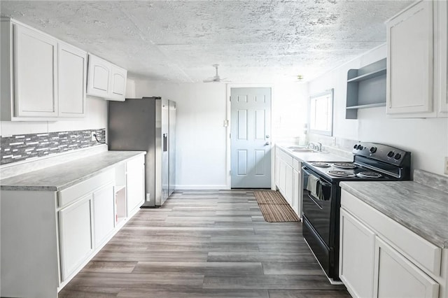 kitchen featuring white cabinets, black range with electric stovetop, sink, stainless steel refrigerator with ice dispenser, and ceiling fan