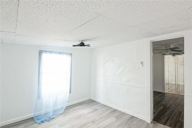 spare room with light hardwood / wood-style floors and ceiling fan