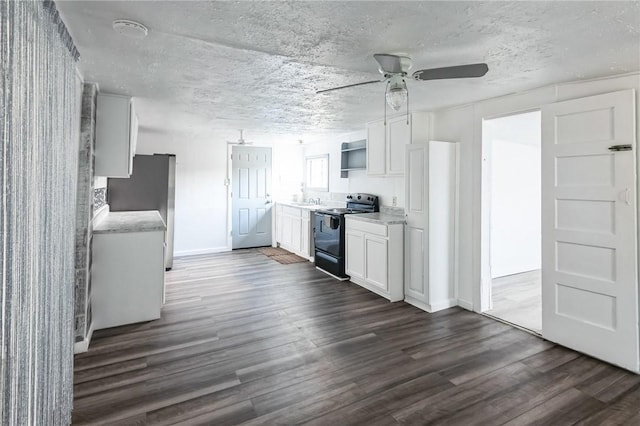 kitchen with stainless steel refrigerator, black / electric stove, ceiling fan, and white cabinets