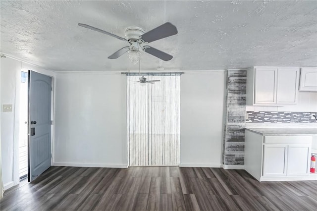 interior space featuring a textured ceiling, ceiling fan, and dark hardwood / wood-style floors