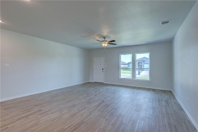 spare room featuring ceiling fan and light hardwood / wood-style flooring