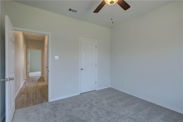 unfurnished bedroom featuring a closet, ceiling fan, and light colored carpet