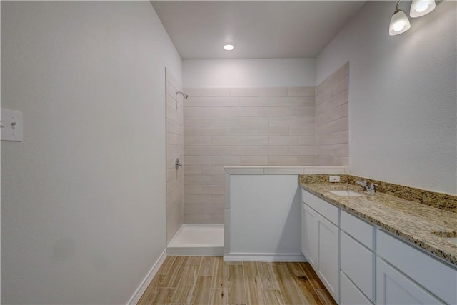 bathroom with walk in shower and vanity