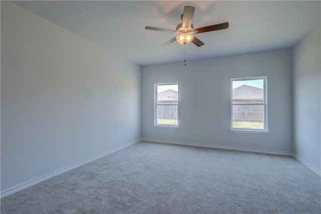 carpeted spare room with ceiling fan