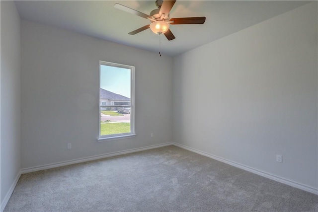 unfurnished room featuring ceiling fan and carpet