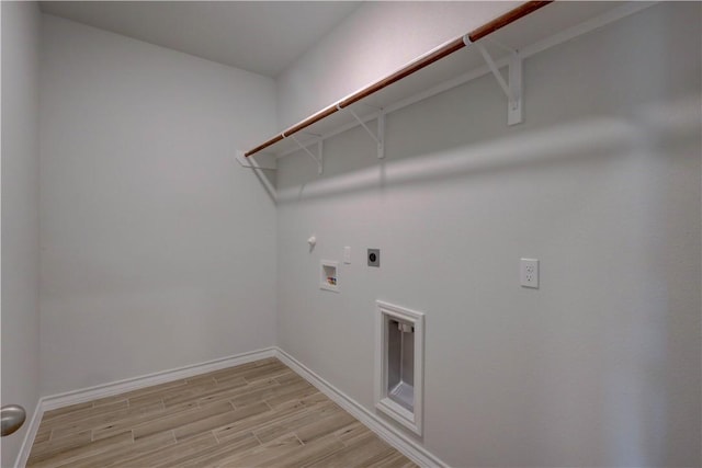 clothes washing area featuring hookup for a washing machine, light wood-type flooring, hookup for an electric dryer, and gas dryer hookup