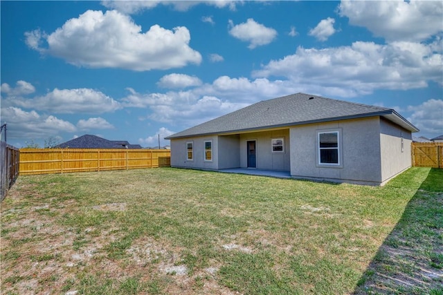 back of house with a lawn and a patio area